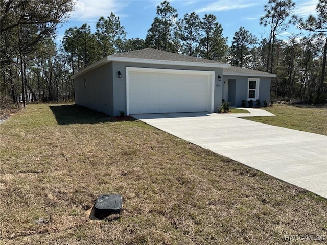 ranch-style home with a front lawn, concrete driveway, an attached garage, and stucco siding