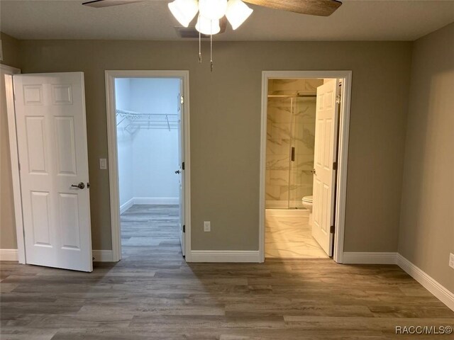 full bath with toilet, marble finish floor, a stall shower, and vanity