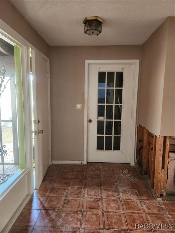 entryway featuring a textured ceiling