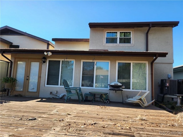 back of property featuring a deck and central air condition unit