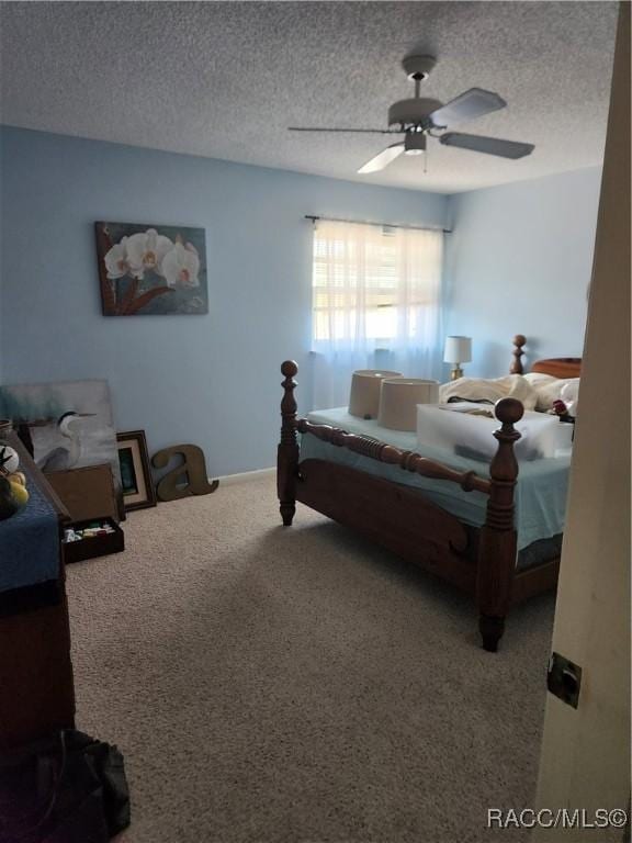 bedroom with ceiling fan, a textured ceiling, and carpet flooring