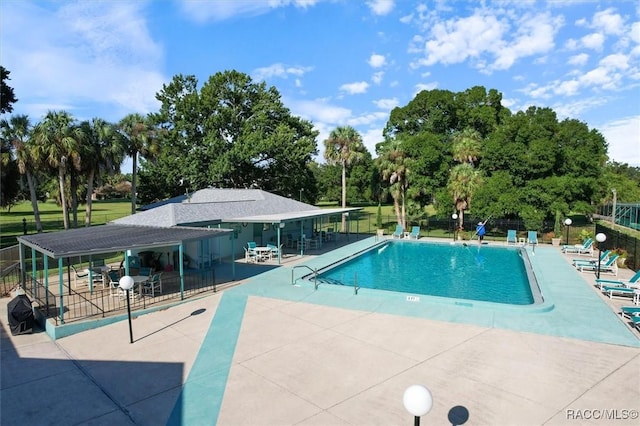 view of swimming pool featuring a patio area