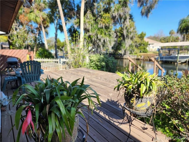 wooden deck featuring a water view