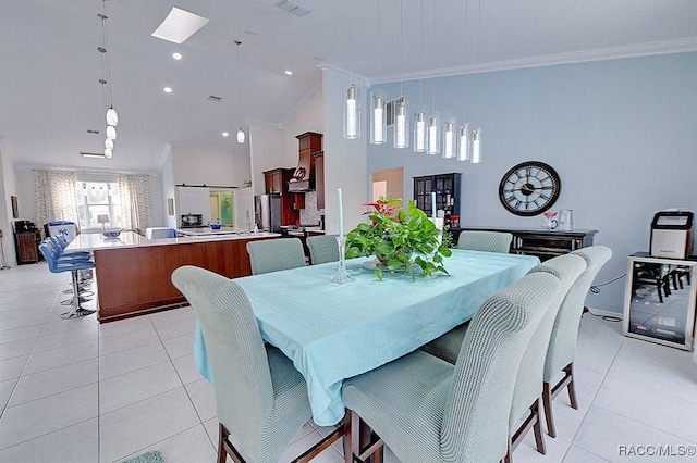 dining room with lofted ceiling, light tile patterned flooring, crown molding, and recessed lighting