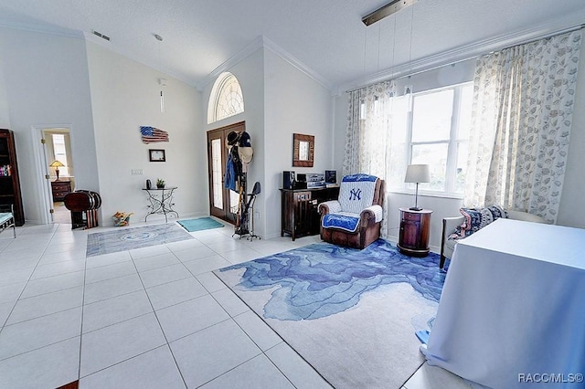 tiled entrance foyer with ornamental molding, lofted ceiling, visible vents, and a textured ceiling