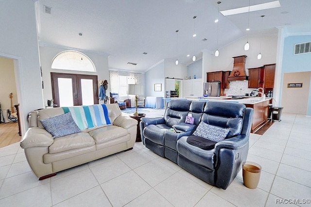 living room with light tile patterned floors, visible vents, high vaulted ceiling, and ornamental molding