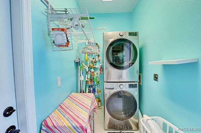 laundry room featuring laundry area and stacked washer and clothes dryer