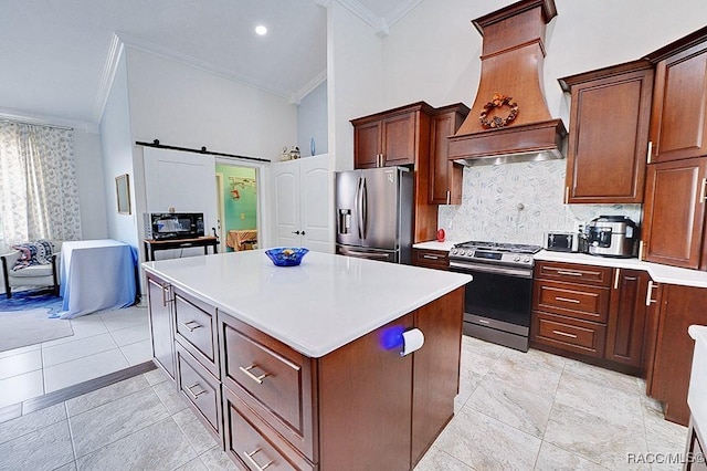 kitchen featuring a center island, stainless steel appliances, a barn door, ornamental molding, and premium range hood