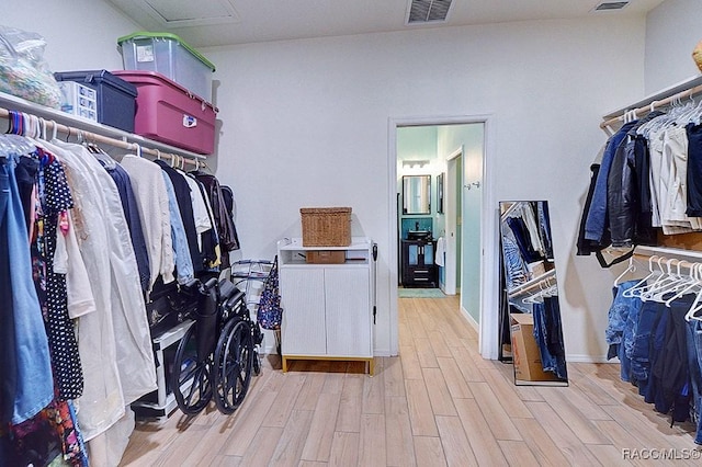 walk in closet featuring light wood-style floors and visible vents