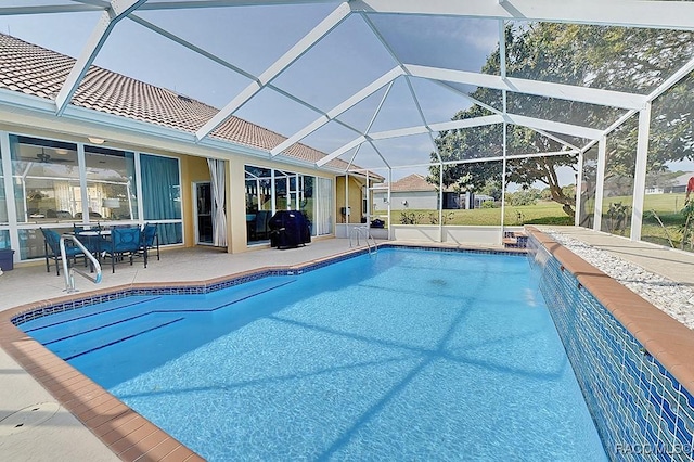 outdoor pool with glass enclosure and a patio