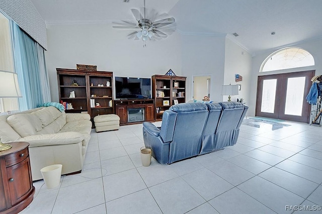 living area with french doors, crown molding, light tile patterned floors, visible vents, and ceiling fan