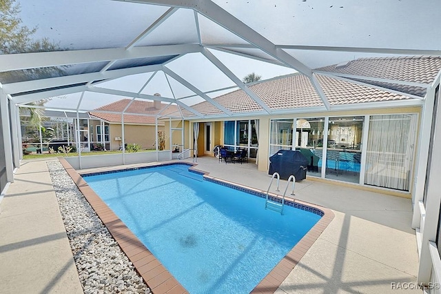 pool with a patio and a lanai