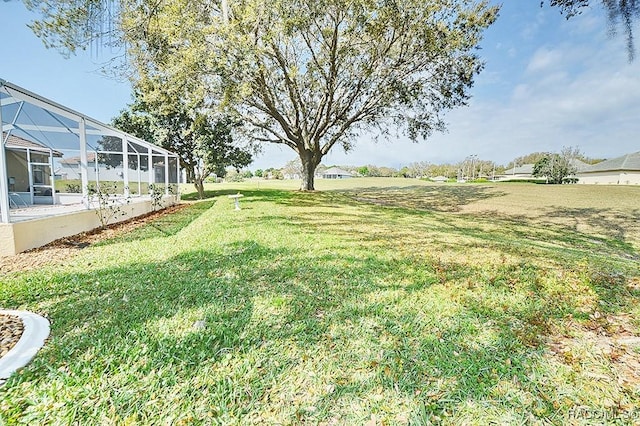 view of yard with glass enclosure