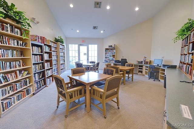 dining space with high vaulted ceiling, recessed lighting, visible vents, and light colored carpet