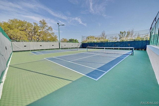 view of tennis court with fence