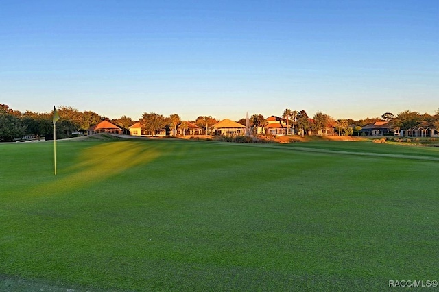 view of property's community featuring a residential view and a yard