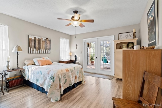 bedroom with ceiling fan, a textured ceiling, access to outside, and french doors