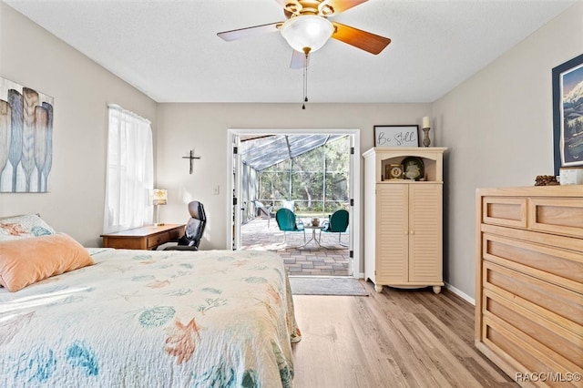 bedroom featuring ceiling fan, a textured ceiling, access to outside, and light hardwood / wood-style flooring