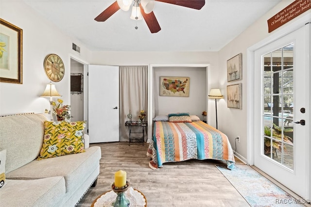 bedroom with ceiling fan, access to exterior, and wood-type flooring