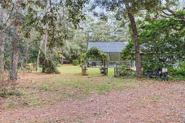 view of yard featuring glass enclosure