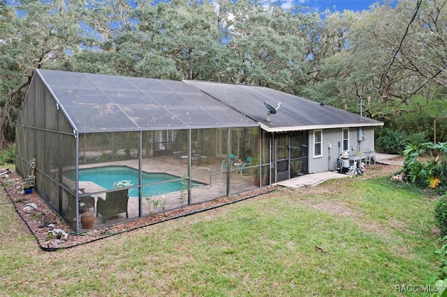 exterior space featuring a patio, glass enclosure, and a lawn