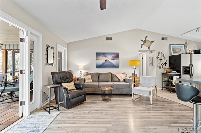 living room with light hardwood / wood-style flooring, ceiling fan, and lofted ceiling