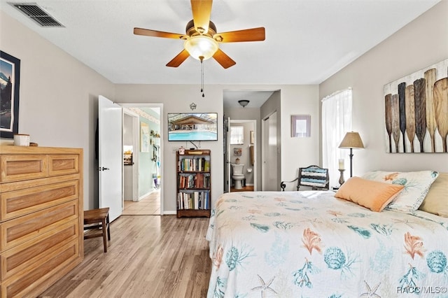 bedroom featuring ensuite bathroom, ceiling fan, and light hardwood / wood-style floors