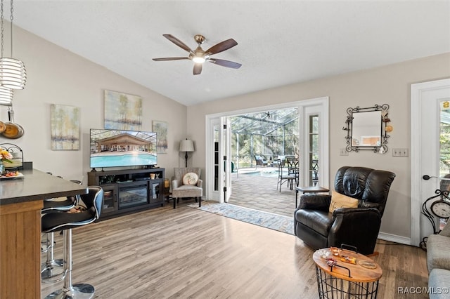 interior space featuring hardwood / wood-style flooring, ceiling fan, and lofted ceiling