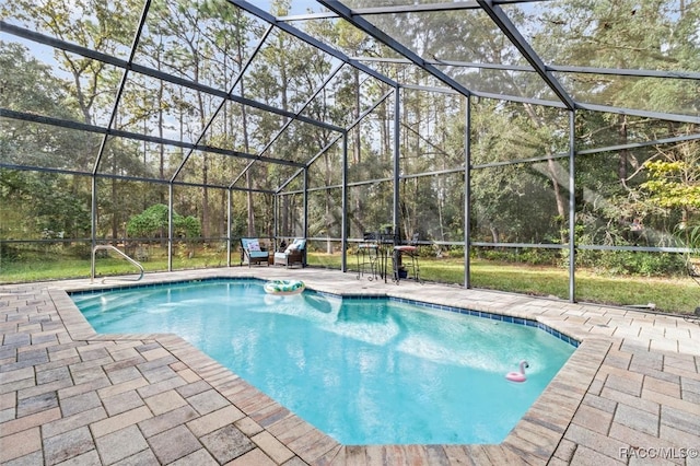 view of swimming pool featuring a lanai and a patio area