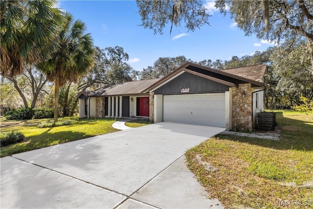 ranch-style house featuring a front yard and a garage