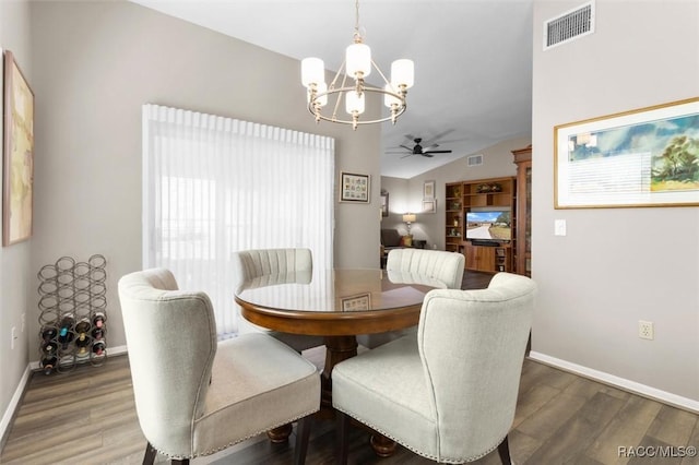 dining area featuring ceiling fan with notable chandelier, wood-type flooring, and vaulted ceiling