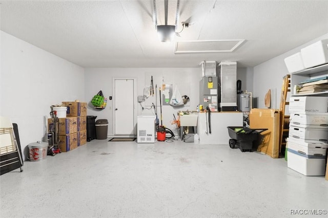 garage featuring heating unit and sink