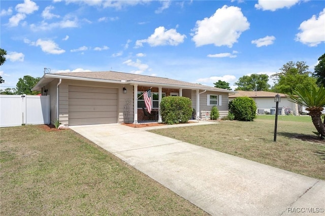 7 Colorado St, Beverly Hills, FL 34465 - ranch-style home featuring fence, an attached garage, driveway, and a front lawn