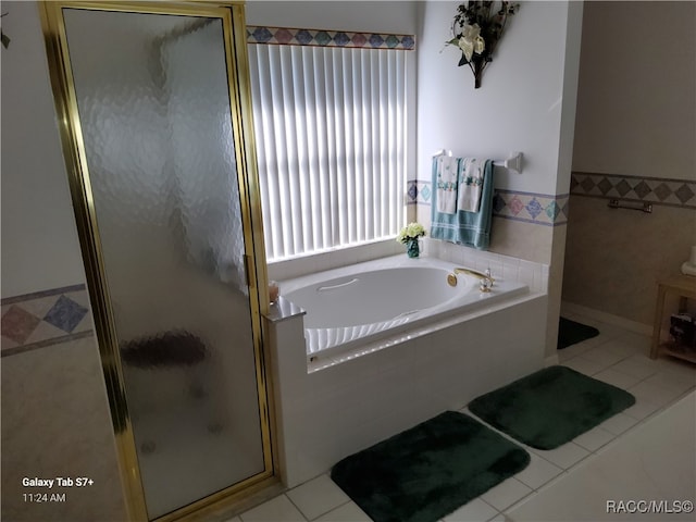 bathroom featuring separate shower and tub and tile patterned floors