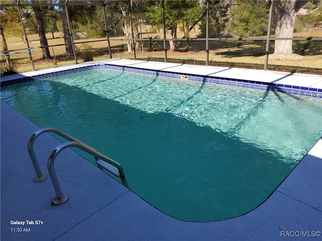 view of pool with a lanai