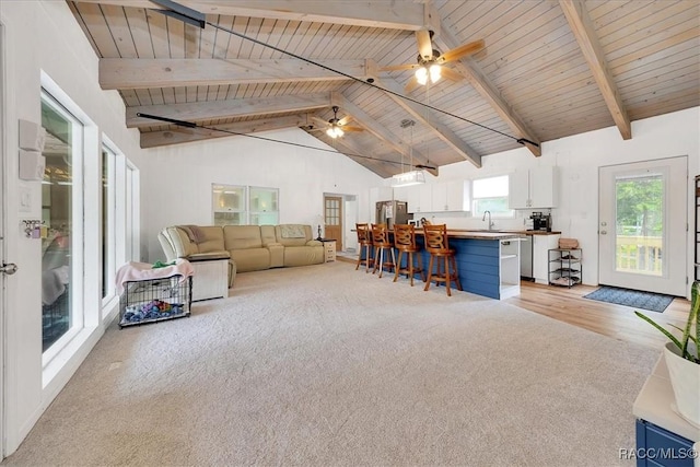 11615 N Caribee Pt, Inglis, FL 34449 - living area featuring wood ceiling with exposed beams, ceiling fan, high vaulted ceiling, and light wood-style floors