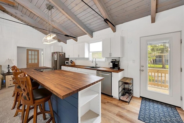 11615 N Caribee Pt, Inglis, FL 34449 - kitchen with wood counters, appliances with stainless steel finishes, wooden ceiling, a sink, and light wood finished floors