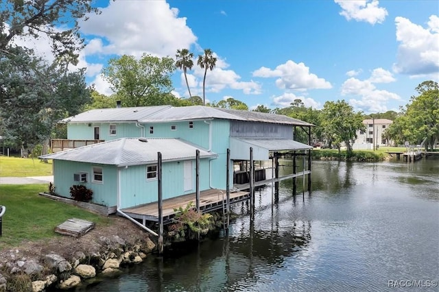 11615 N Caribee Pt, Inglis, FL 34449 - dock with a water view, boat lift, and a lawn