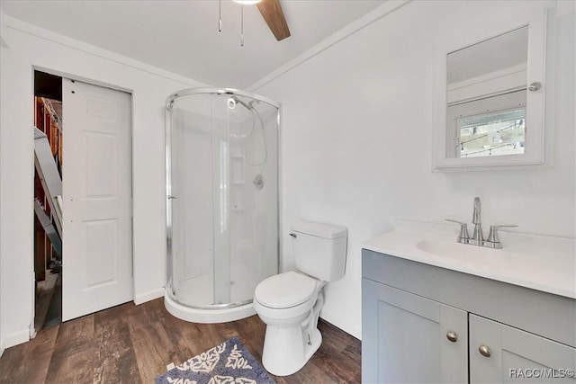 11615 N Caribee Pt, Inglis, FL 34449 - full bathroom with a shower stall, vanity, wood finished floors, toilet, and ceiling fan