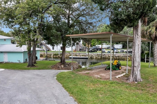 11615 N Caribee Pt, Inglis, FL 34449 - view of home's community featuring a lawn, a water view, and a detached carport
