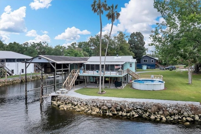 11615 N Caribee Pt, Inglis, FL 34449 - dock with stairs, a lawn, a patio area, and a deck with water view