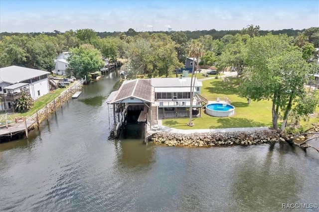 11615 N Caribee Pt, Inglis, FL 34449 - dock featuring a water view, boat lift, and a yard