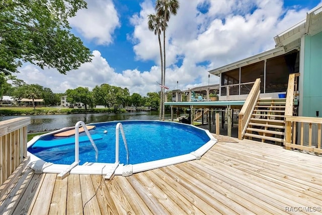 11615 N Caribee Pt, Inglis, FL 34449 - view of swimming pool with stairs, a deck with water view, and a sunroom