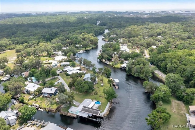 11615 N Caribee Pt, Inglis, FL 34449 - aerial view of property's location featuring a nearby body of water, a heavily wooded area, and nearby suburban area