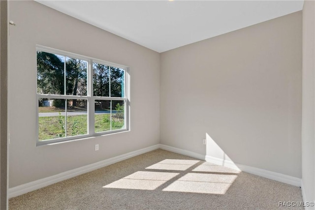 carpeted spare room with baseboards