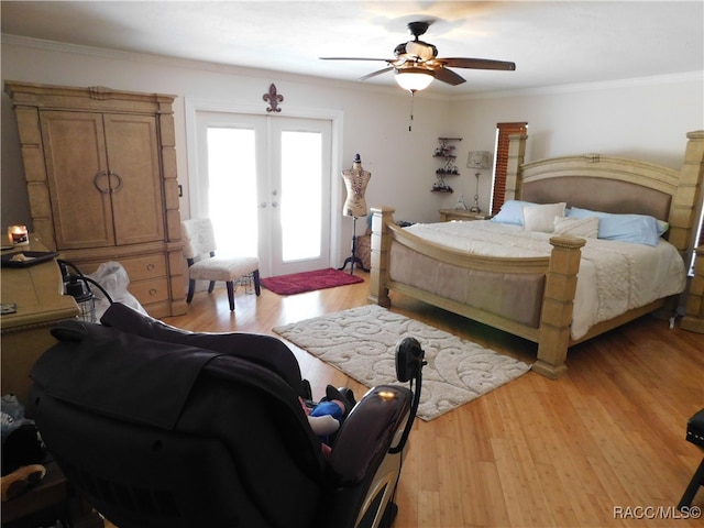 bedroom featuring ceiling fan, light hardwood / wood-style flooring, crown molding, and french doors