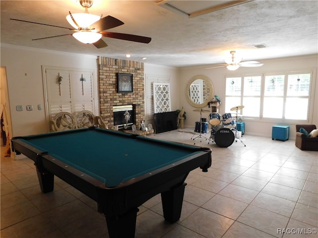 playroom featuring tile patterned floors, a textured ceiling, ceiling fan, billiards, and a fireplace