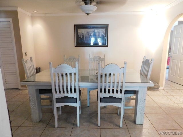 dining room with light tile patterned floors and ornamental molding