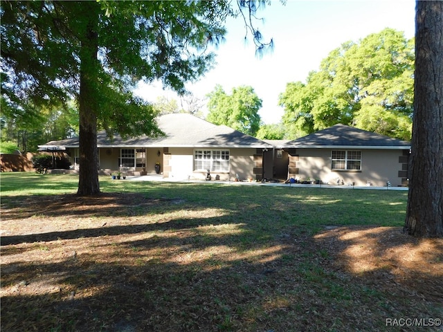 back of house with a lawn and a patio area