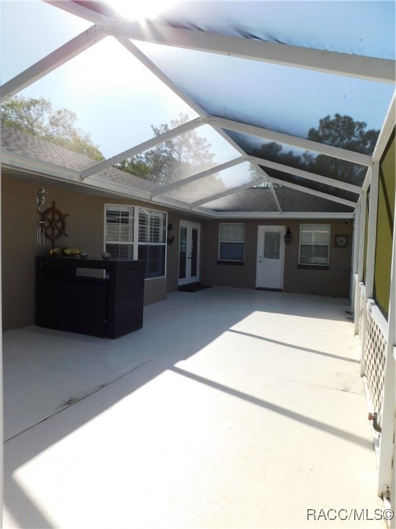 view of patio / terrace featuring glass enclosure and french doors